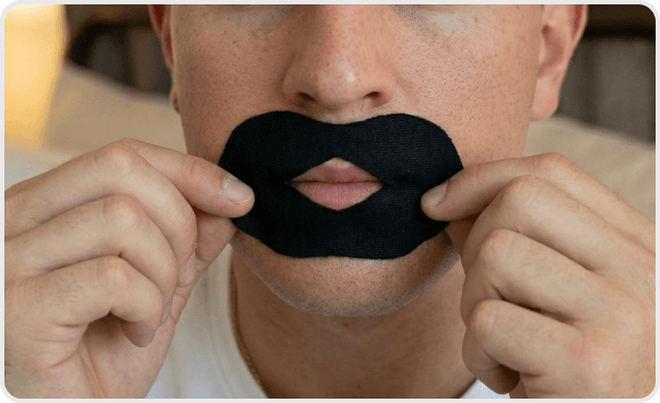 Stretch and position tape over closed lips