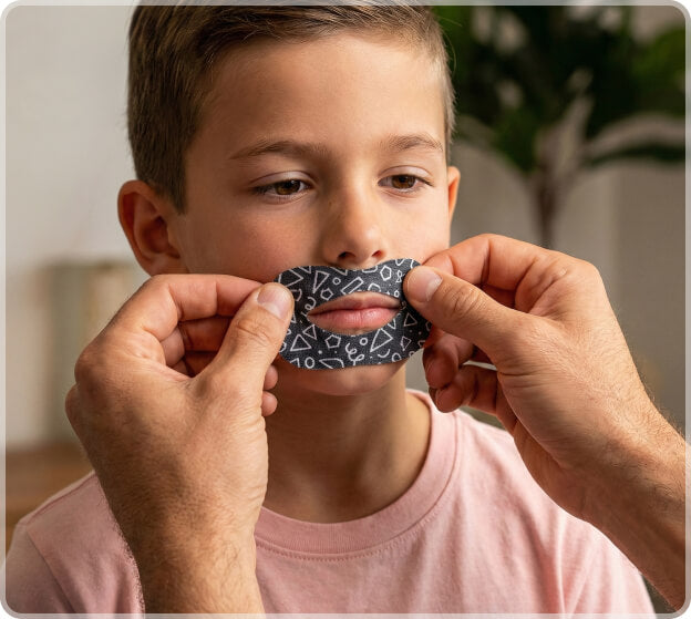 Gently stretch the tape while placing it over the mouth.